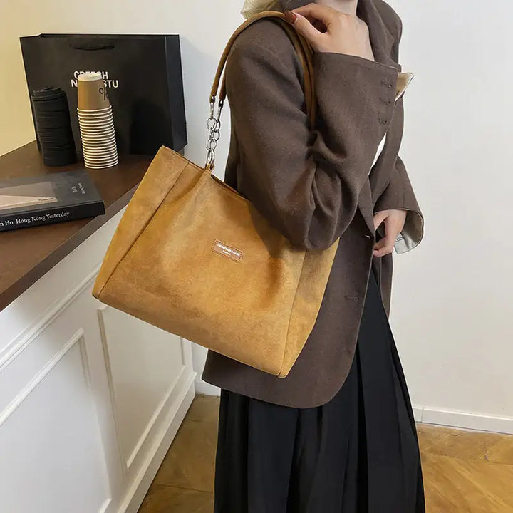 Ockerfarbene Handtasche mit Kettendetails. Damenmode bei IsabellBoutique030.